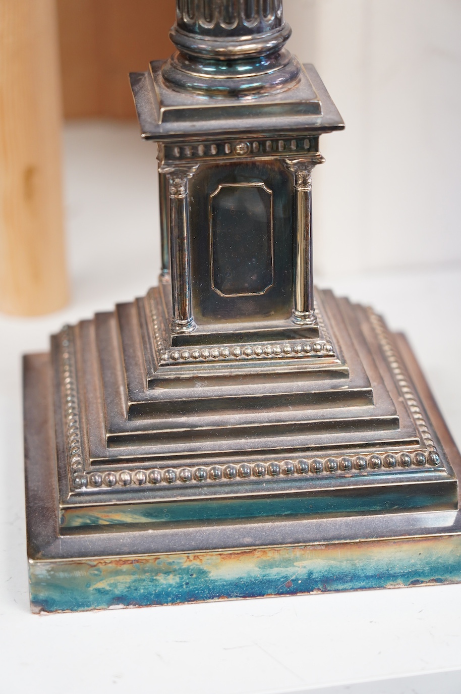 A silver plated oil lamp in the form of a Corinthian column with cut glass reservoir, 76cm high. Condition - fair to good, missing chimney and shade